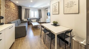 A modern living space with a kitchen, dining area, and seating. - Ático Corazón de Madrid Apartamento B (Madrid)