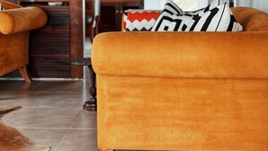 Ein Wohnzimmer mit einer Couch, einer Lampe und einem Bücherregal.