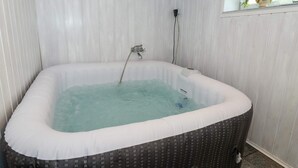 A hot tub in a room with white walls and a window. - 10 Person Holiday Home in Bovlingbjerg (Bøvlingbjerg)