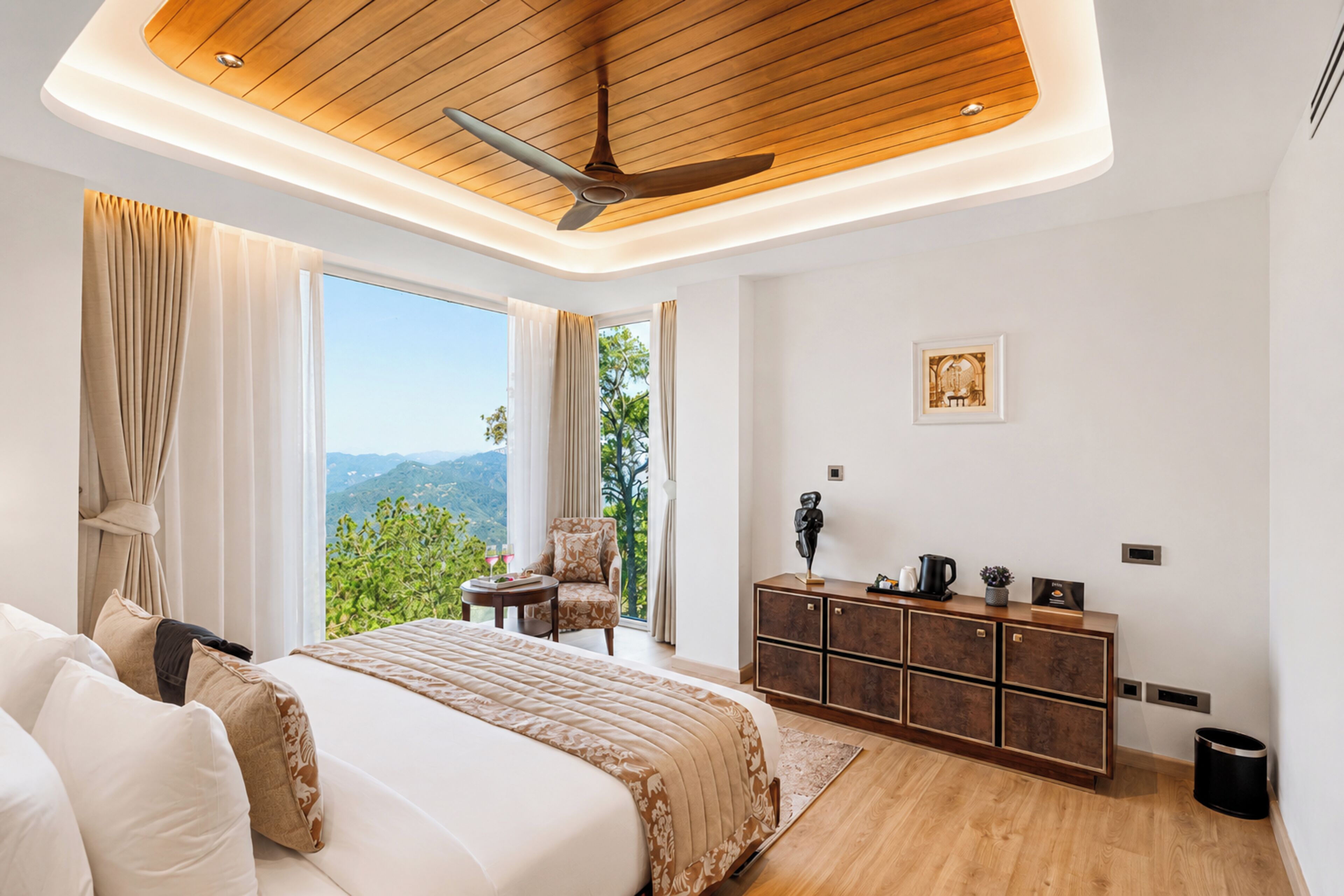 A bedroom with a bed, a chair, a desk, a cabinet, and a view of the outdoors.