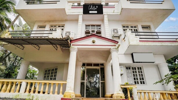 A large, white building with a central entrance, columns, and a balcony. - Deluxe With Balcony Calangute Goa (Calangute)