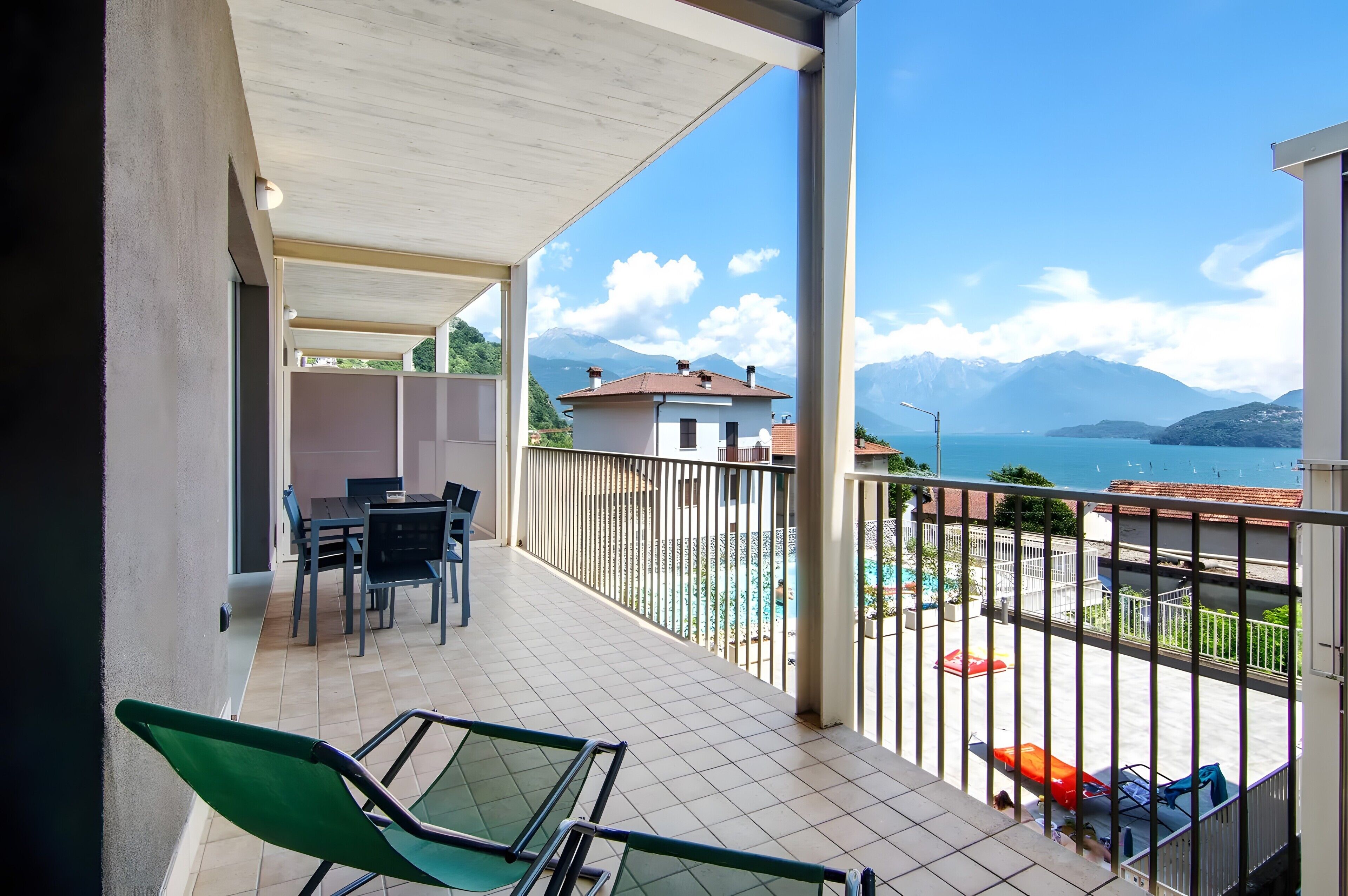 Un balcone con vista sulle montagne e su una piscina.