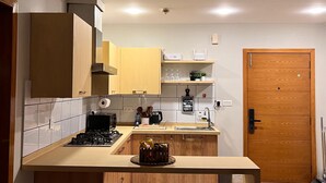 A modern kitchen with a central island, wooden cabinets, and a built-in stove.
