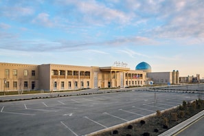 A large building with a dome and a sign that reads 'Crystal Creek.' - Arda Oasis (Khiva)