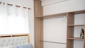 A bedroom with a bed, a wardrobe, and a window with curtains. - Luxurious Punta Cana House 3 Bedrooms, Shared Pool, BBQ (Punta Cana)