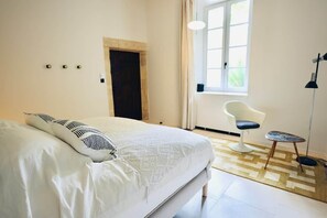 A bedroom with a bed, a chair, a lamp, and a window. - Louna room (Saint-Victor-la-Coste)