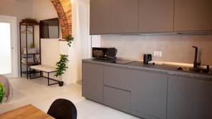 A modern kitchen with grey cabinets, a microwave, and a coffee machine. - Switch holiday 314 (La Spezia)