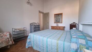 Un dormitorio con cama, cómoda y espejo.