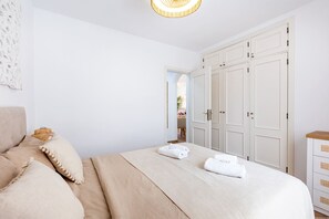 A bedroom with a bed, pillows, a wardrobe, and a bedside table. - Yucca Park 40 - One Bed (Costa Adeje)