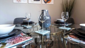 A dining table with a vase, two wine glasses, and a bowl. - Central, Secure Parking and High-end (Nottingham)