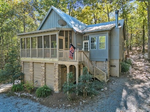A cabin with a balcony, a flag, and a chimney. - New! 2 bedroom/2 bath water access cabin at Lake Martin! Sleeps 8! (Dadeville)
