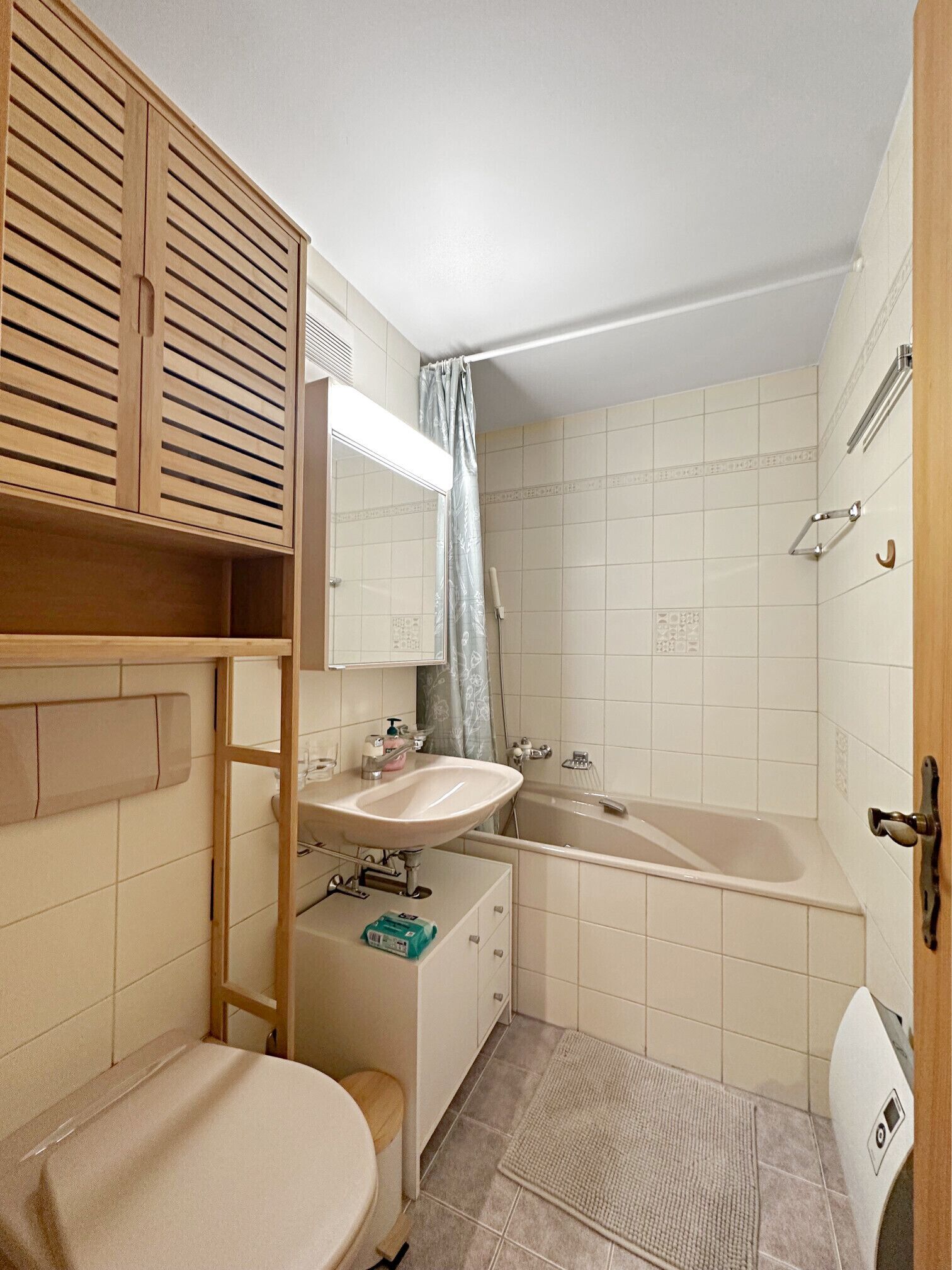 A compact bathroom with a sink, toilet, and bathtub.
