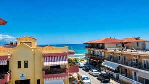 A coastal hotel with balconies, a beach view, and a clear sky. - New Horizon Sarti - Double Room With Balcony G3 (Sithonia)