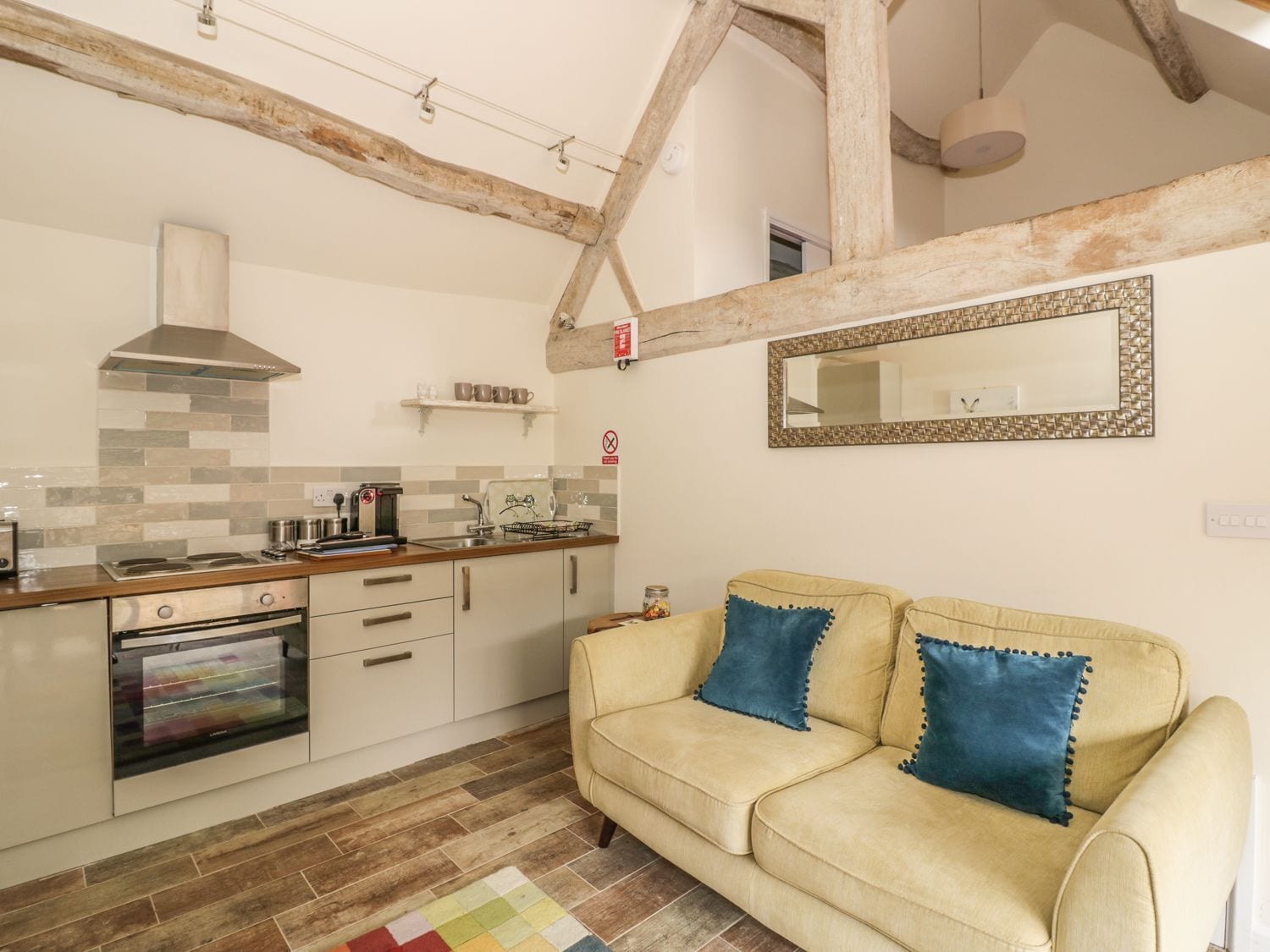 A kitchen with a stove, oven, and hanging lights.