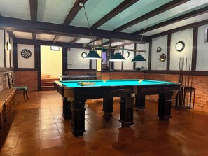 A billiards room with a pool table, chairs, and a dartboard. - SEAS THE DAY 2 (Luz)