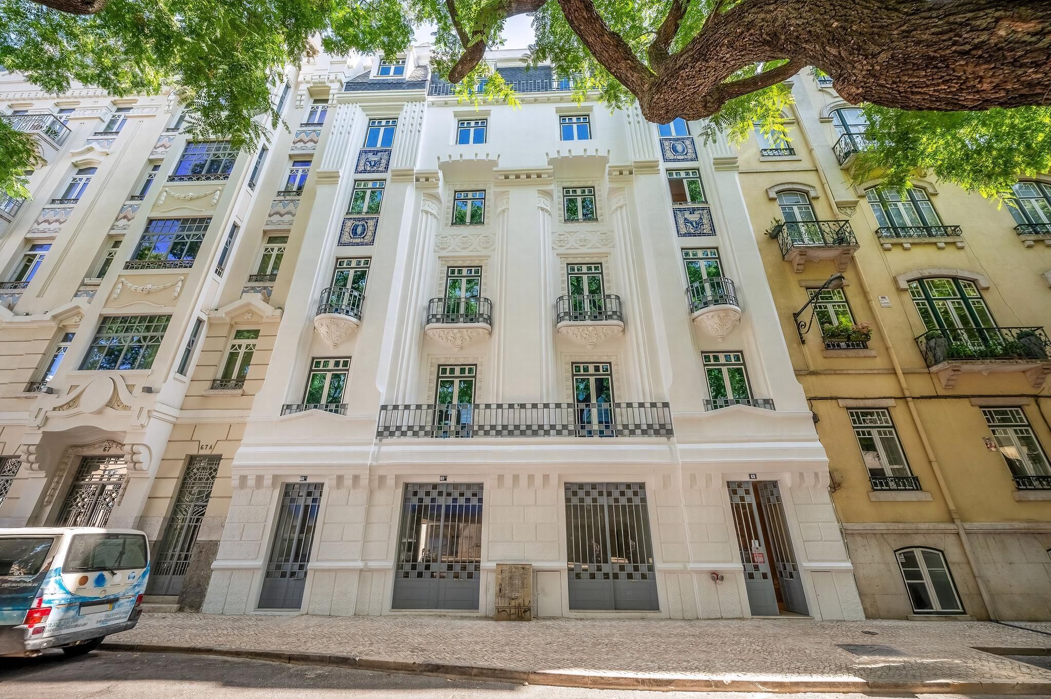 A multi-story building with ornate architectural details, including columns and decorative window frames.