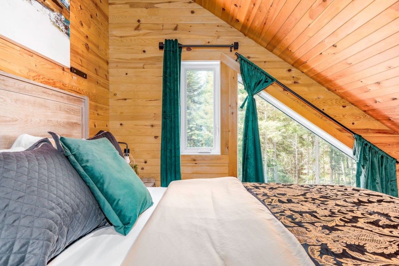 A bedroom with a bed, curtains, and a window.