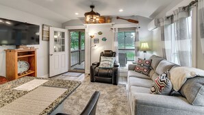 A living room with a television, a fireplace, a sofa, and a chair. - Waterfront Couples Retreat w/ Views in Andalusia! (Andalusia)