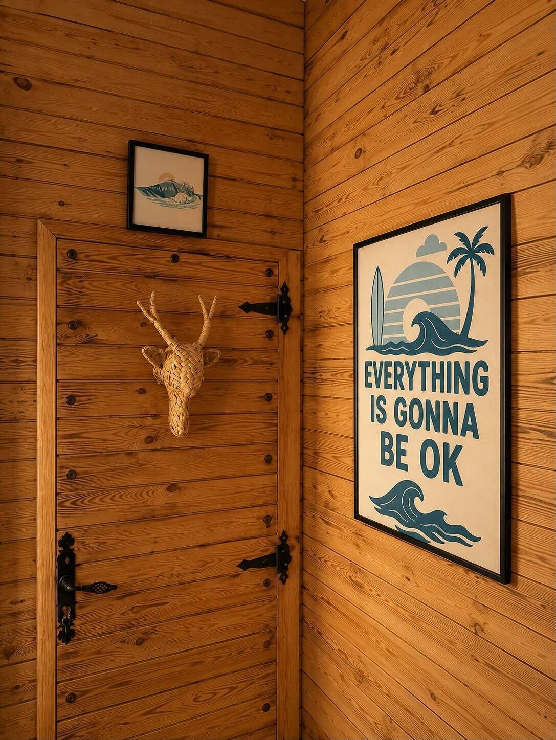 A wooden door with a deer head decoration and a framed motivational quote.