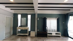 A room with a wooden floor, a white vanity with a mirror, a bench, and a window with curtains. - PAPA Beach Pool Villas Pattaya (Bang Lamung District)