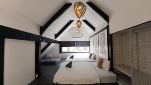 A modern bedroom with a sloped ceiling, a bed with pillows, a bench, and a large window. - PAPA Beach Pool Villas Pattaya (Bang Lamung District)