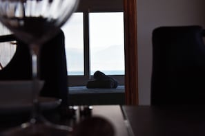 A room with a bed, a window, and a lamp. - Elysian Blue (Petalidi)