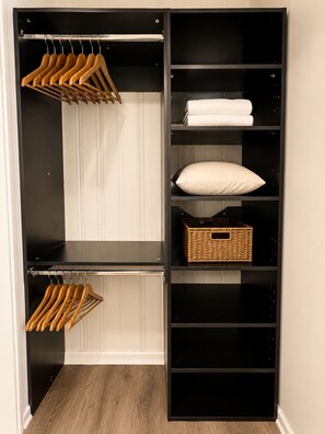A walk-in closet with multiple shelves, a hanging rod, and a basket. - Stylish & Modern 2BR Suite -Private Entry - Prime Location (Atlanta)