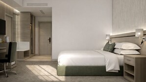 Ein modernes Hotelzimmer mit Bett, Nachttischen, Schreibtisch und Stuhl.