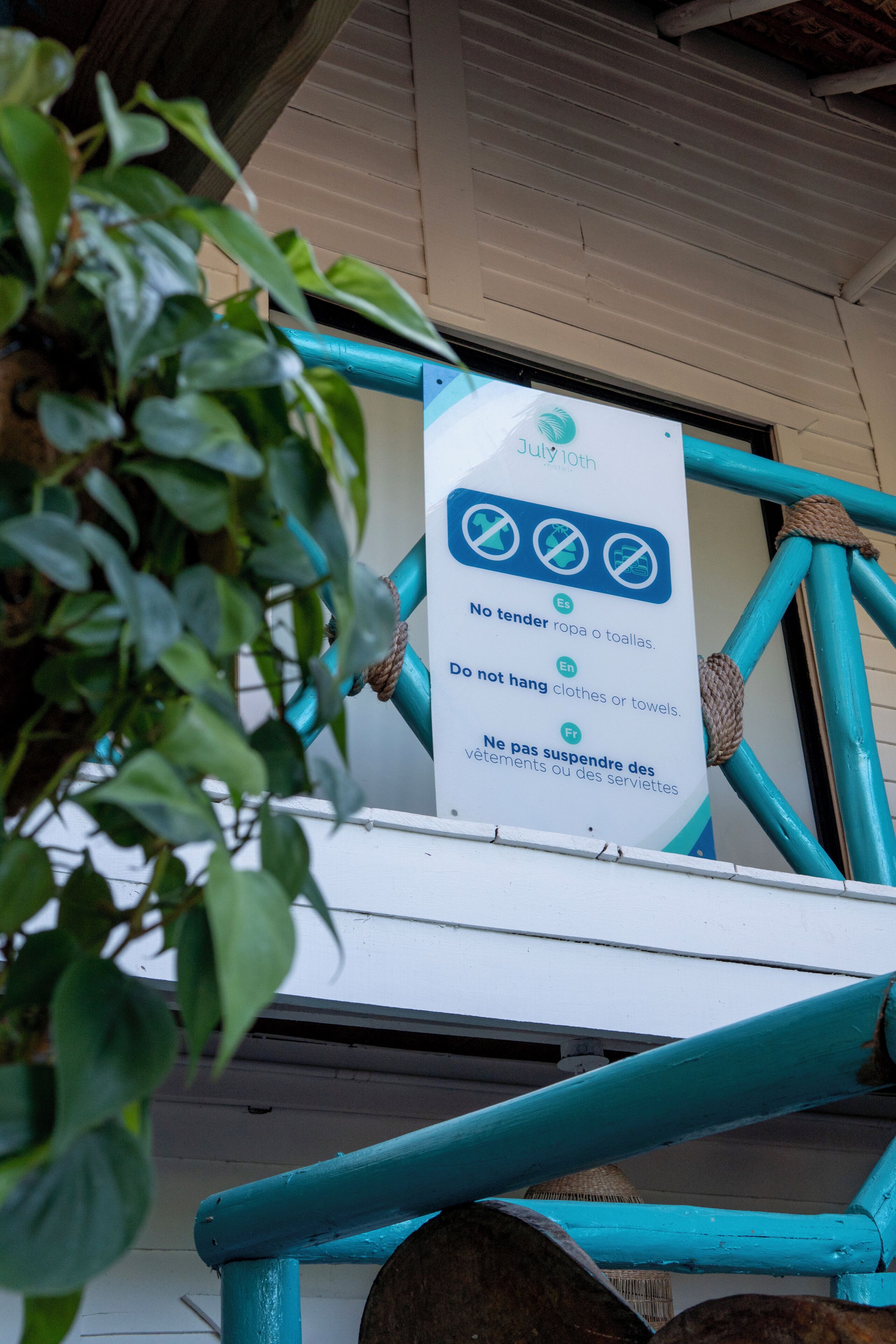 A sign with multilingual instructions in a public space.