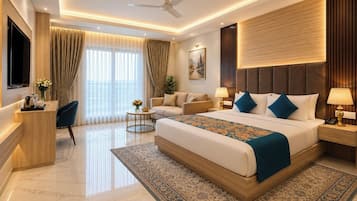 A modern hotel room with a large bed, a desk, a sofa, a TV, and a ceiling fan.