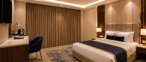 A hotel room with a bed, a desk, a chair, a television, and a ceiling fan.