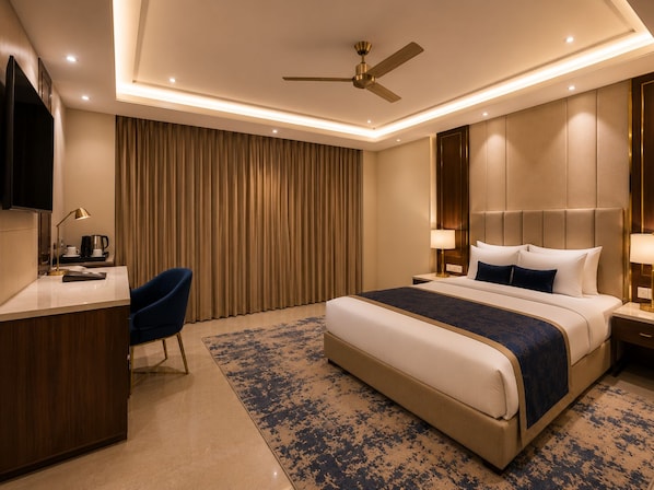 A hotel room with a bed, a desk, a chair, a television, and a ceiling fan.