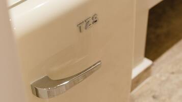 A white cabinet with a handle and the letters 'TZS' on the front.