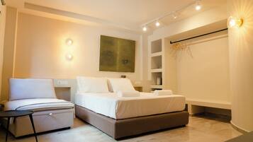 A modern bedroom with two beds, a bedside table, a wall-mounted shelf, and a painting.