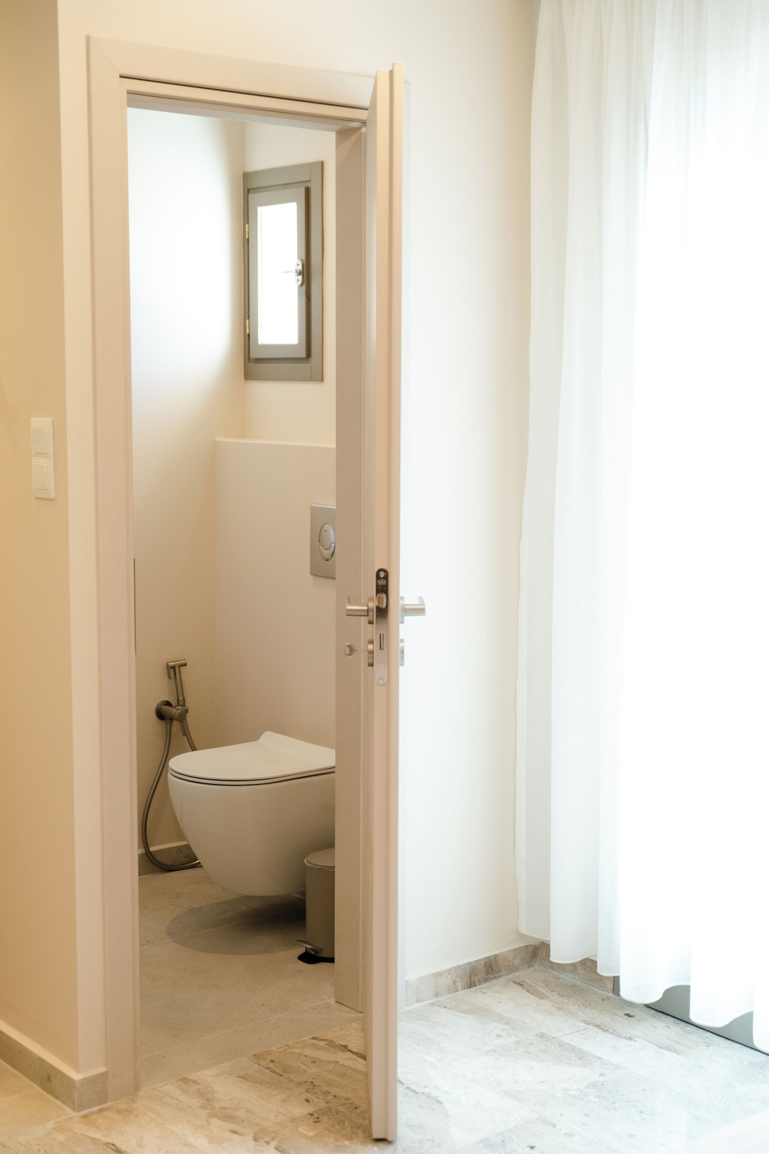 A bathroom with a toilet, bidet, and shower.