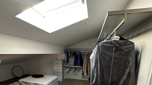 A bedroom with a skylight, a bed, a wardrobe, and a closet. - The Loft – Designer Apartment in Castel San Pietro Terme (Castel San Pietro Terme)