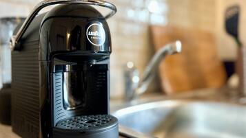 A coffee maker with a drip tray on a kitchen counter.