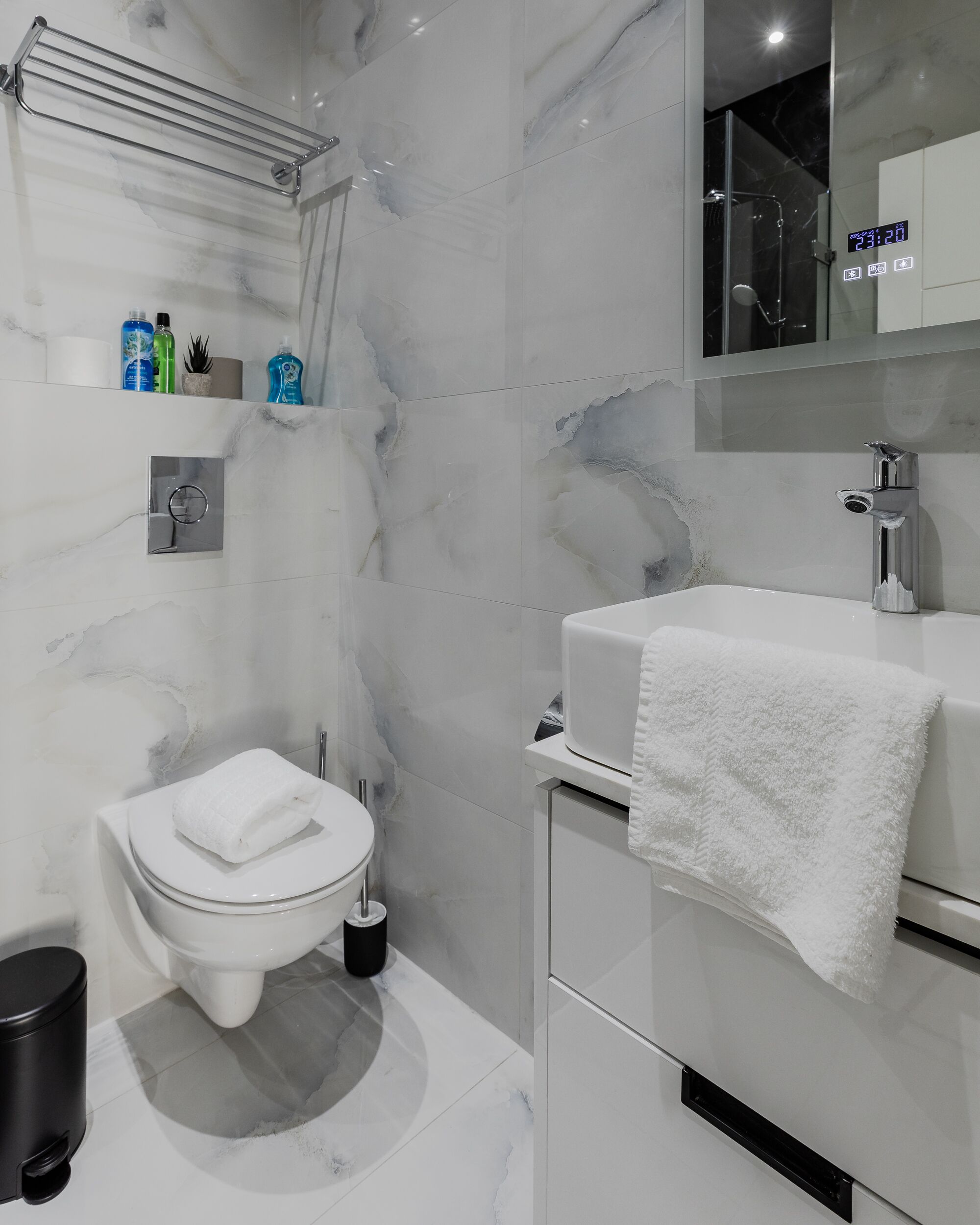 A modern bathroom with a toilet, bidet, and sink.
