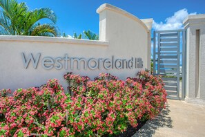 A sign for Westmoreland Hill with a gated entrance and lush greenery. - Luxury 4BR Villa | Pool | Beach Club | West Coast (Saint James)