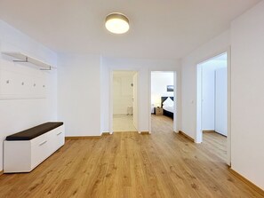 A hallway with wooden flooring, white walls, and doors leading to other rooms. - Cosy apartment for 5 guests with WIFI, TV and balcony (Endingen)