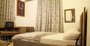 Desk, laptop workspace, blackout curtains, soundproofing - Romford 64 Apartment (Galadimawa)