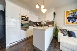A modern kitchen with white cabinetry, stainless steel appliances, and a central island. - St. Julian's Apartment 502 - Near Beach &Paceville (Saint Julian's)