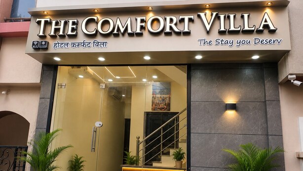 A hotel entrance with a sign reading 'The Comfort Villa' and a slogan 'The Stay you Deserve'.