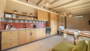 Una cocina compacta con armarios de madera, una cafetera y un horno empotrado.