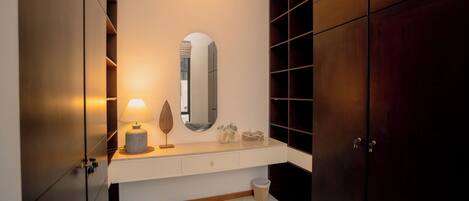 A modern bathroom with a vanity, mirror, and wooden cabinets.
