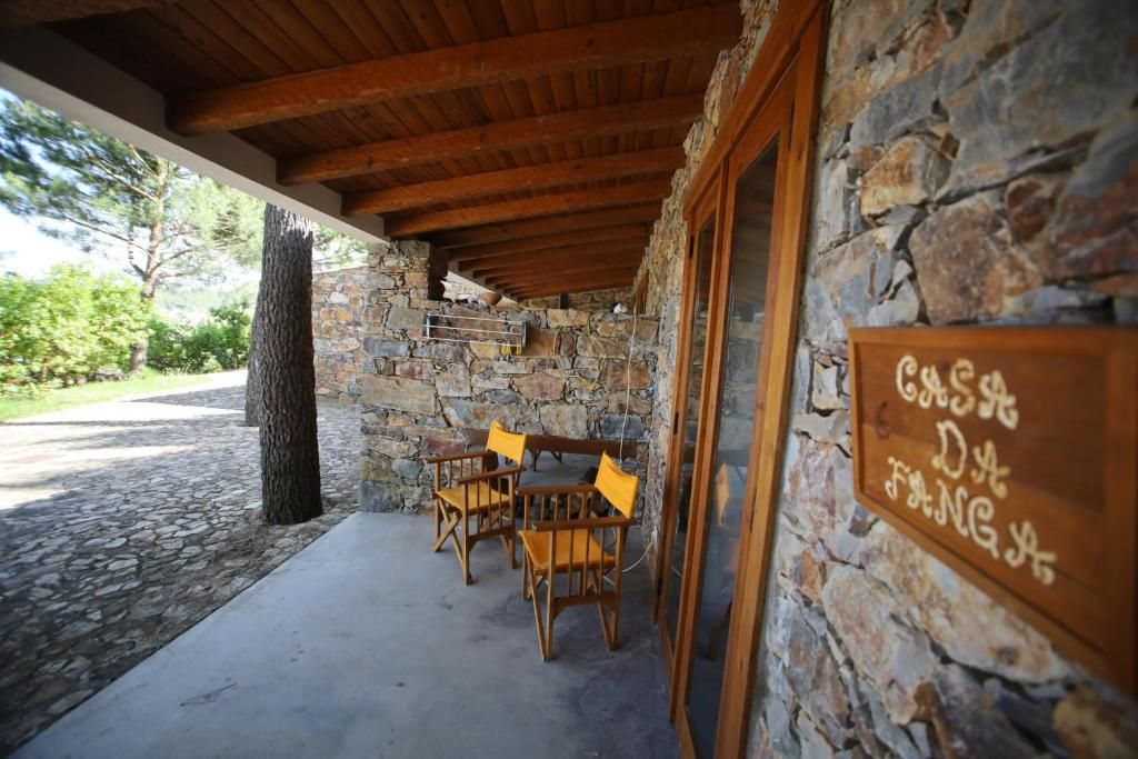 A stone building with a wooden ceiling and a sign reading 'CASA D'ANGS'.