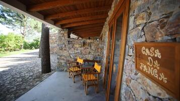 A stone building with a wooden ceiling and a sign reading 'CASA D'ANGS'.