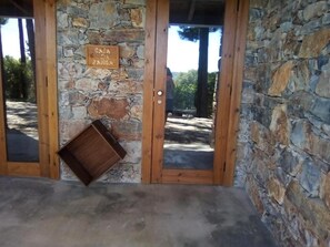 A stone wall with a wooden door and a small wooden box.
