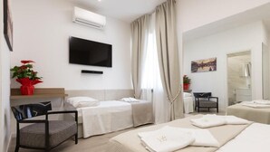 A hotel room with a bed, two bedside tables, a TV, a chair, and a window with curtains.