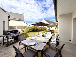 An outdoor patio with a grill, dining table, chairs, and umbrellas. - Family Home, a 10-minute walk from the beach - 4 suites with private bathrooms (Quiberon)